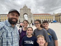 a group of people posing for a photo in front of a building